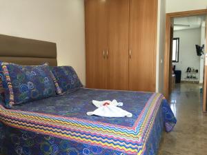 a bedroom with a bed with a towel on it at Beau studio à Rabat calme et sécurisé in Rabat