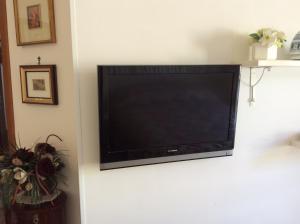 a flat screen tv hanging on a wall at Residenza Guarna in Salerno