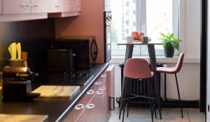 a kitchen with a counter with a stove and a table at #Groentemarkt1 in Ostend
