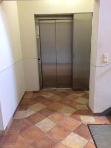 a hallway with two elevators in a building at Ferienwohnung zum Storchennest in Bad Liebenwerda