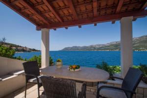 a table on a patio with a view of the water at Sunset Apartments in Korčula