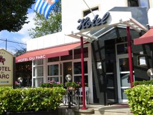 a restaurant with a sign on the front of it at Hotel du Parc in Diekirch