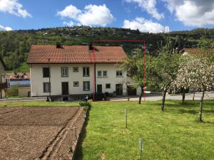 a house with a garden in front of it at La montagne in La Bresse