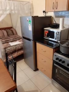 Kuchyň nebo kuchyňský kout v ubytování Mercy-Phillips Apartments Located at Eagle Tower Building Nairobi City Centre + 37 fotografií