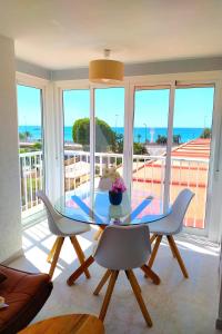 a dining room with a glass table and white chairs at Fantastic Seaview Apartment in Alicante