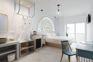 a bedroom with a bed and a desk with a chair at Mylos Luxury Escape in Faliraki