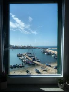 a window view of a marina with boats in the water at Port'Amare in Bari