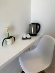 a white table with a tea kettle and two cups on it at Port'Amare in Bari