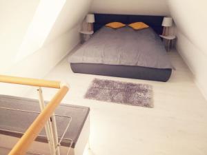 a small bedroom with a bed in a attic at De Luxe Blue Mare in Łukęcin +119 photos