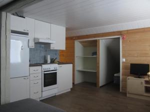 a kitchen with white cabinets and a white stove at RISTIMÄENKATU 13 in Savonlinna