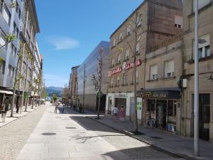 a city street with people walking down a street at Hotel Carabela La Pinta in Baiona