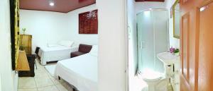 Uma cama ou camas num quarto em Hotel Ciudad Blanca