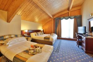 a hotel room with two beds and a television at Best Western Classic Hotel in Reggio Emilia +84 photos