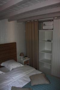 a bedroom with a bed and a night stand with a lamp at Il Sole in Le Puy-Sainte-Réparade