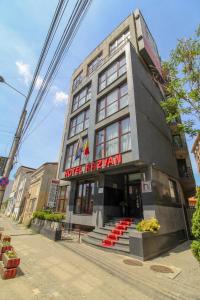 a building with a hotel entrance on a street at Hotel Razvan in Bucharest