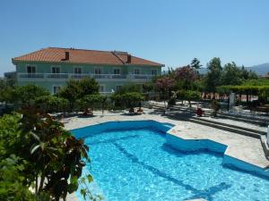 a large swimming pool in front of a building at Evelin hotel in Pythagoreio