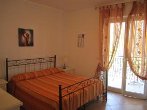 Ένα ή περισσότερα κρεβάτια σε δωμάτιο στο B&B Il Sole Nascente