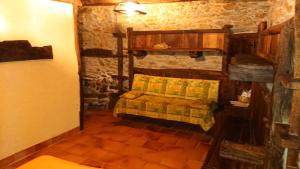 um pequeno quarto com uma cama numa casa de pedra em Casa O´Crego em San Román