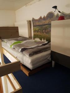 a bedroom with two bunk beds and a painting on the wall at Ferienwohnung Spreter in Zimmern ob Rottweil