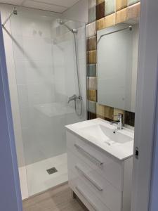 a white bathroom with a sink and a shower at FH COCOLISO I in Altea