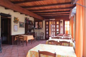a restaurant with tables and chairs in a room at Fattoria Delle Rose in Salussola