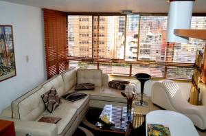 a living room with a couch and a large window at Confortable apto tipo Suite/ Turismo Relax in Caracas