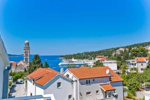 a view of a city with a clock tower and water at Apartments Jacky in Hvar