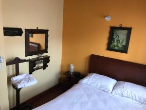 Un pat sau paturi într-o cameră la Casa Posada Maestro Carlos Aranguren