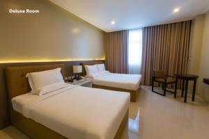Iloilo Gateway Hotel and Suites客房内的一张或多张床位