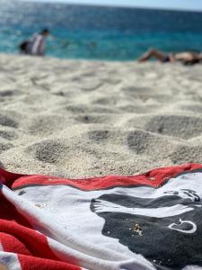 a towel laying on the sand on a beach at I Quattroventi in Muravera