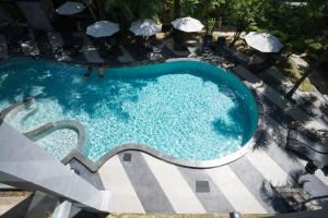 an overhead view of a swimming pool with umbrellas at Kokotel Khao Lak Lighthouse in Khao Lak