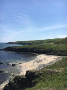 a view of a beach with rocks and the ocean at Дървени къщички - Лион in Sinemorets +29 photos