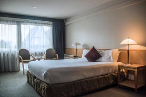Postel nebo postele na pokoji v ubytování Heartland Hotel Queenstown