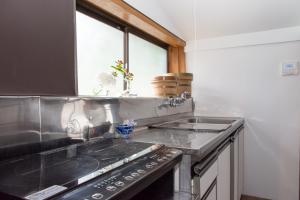 A kitchen or kitchenette at carafuru Japanese Old House