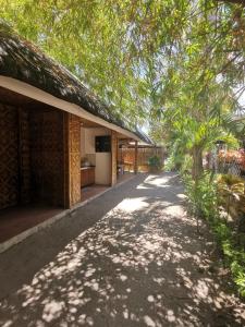 a house with a pathway next to a building at CafeMare Rooms in Bantayan Island