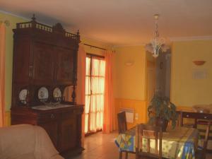 a bedroom with a large wooden cabinet and a table at Le Bois du Gart in Bossus-lès-Rumigny