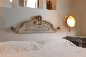 Ένα ή περισσότερα κρεβάτια σε δωμάτιο στο Borgo Sentinella