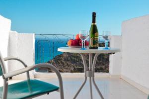 a table with a bottle of wine and two glasses at Iro Hotel in Agia Galini