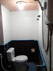 a small bathroom with a toilet and a light at Ok Sukhothai Resort in Sukhothai