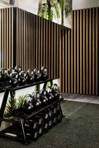 a group of tea pots on a shelf in a room at Zagame's House in Melbourne