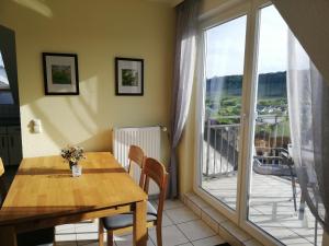 a dining room with a table and a large window at Ferienwohnung Panoramablick in Lieser