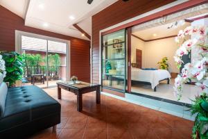 a living room with a bed and a couch at Naiyang Beach Private Pool Villa in Nai Yang Beach