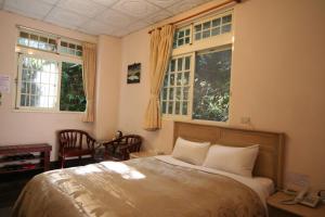 Cama ou camas em um quarto em Cing Jing Homeland Resort Villa