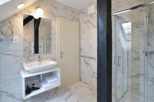 a bathroom with a sink and a shower at Vila Selena in Ljubljana +38 photos