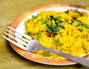 a plate of food with a fork and knife at Hotel Shertown in Ahmedabad