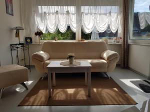 a living room with a couch and a table at Ferienwohnung Eigner in Traben-Trarbach