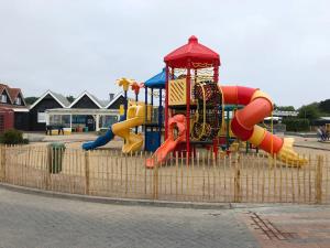 a park with a playground with a slide at Chalet SOL Y MAR in Renesse