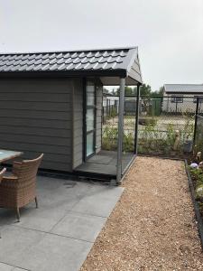 a pavilion with a table and a patio at Chalet SOL Y MAR in Renesse