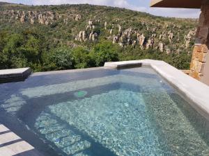 a swimming pool with a view of a mountain at Blyde Canyon, A Forever Resort in Matibidi