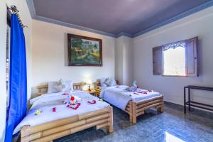 Postel nebo postele na pokoji v ubytování Kacu Ubud Inn